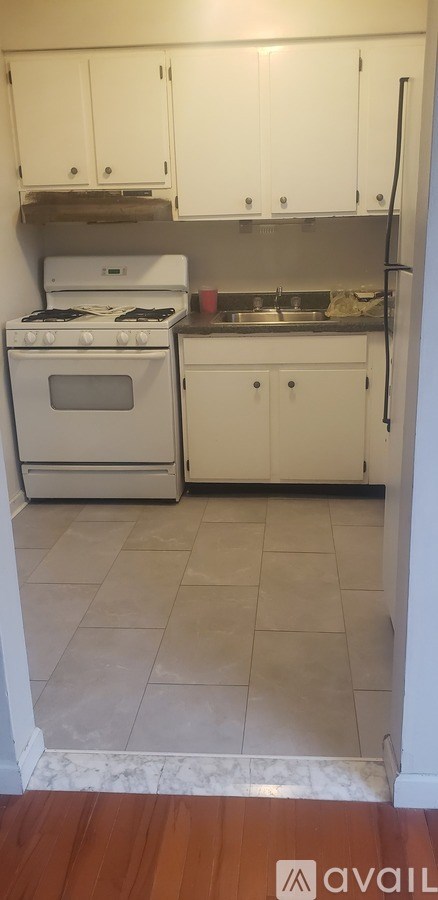 A kitchen with white appliances and cabinets.