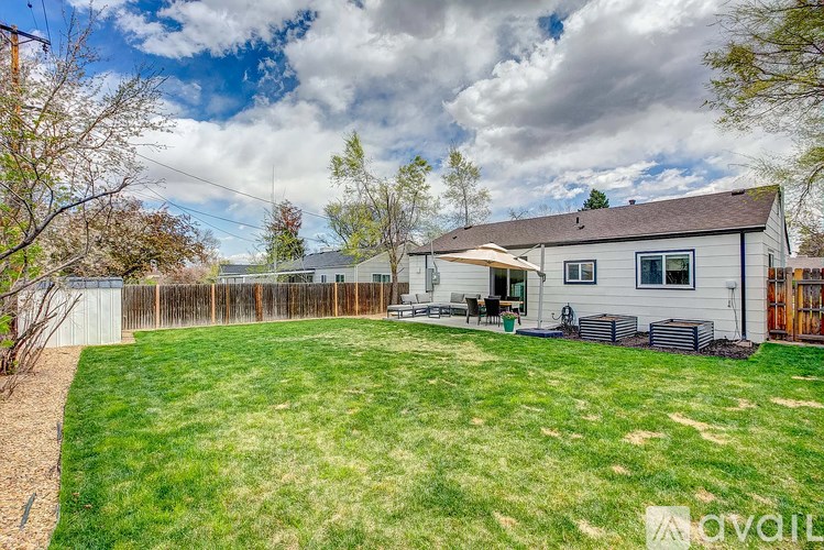 A house with a yard and a fence.