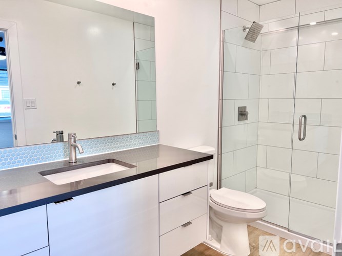 A white toilet sits next to a sink in a bathroom.