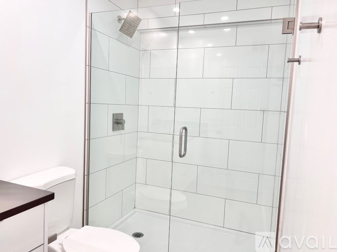 A glass shower stall with a white toilet next to it.