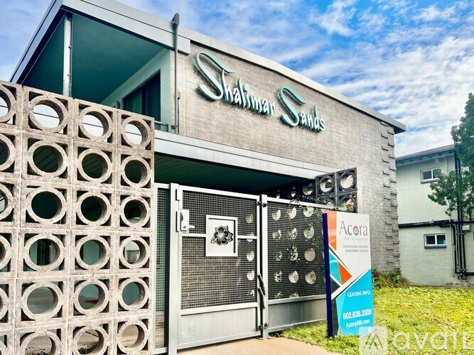 The image shows the exterior of a building with a sign that reads "Shalimar Sands."