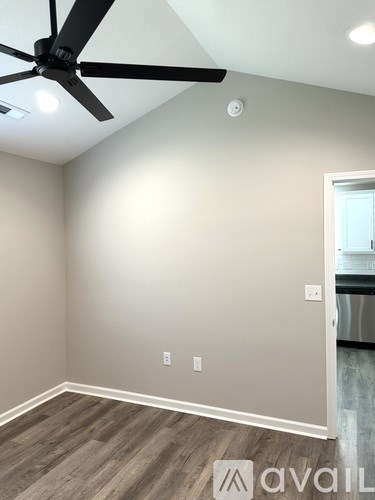 A room with a ceiling fan and light fixture.