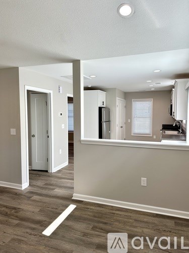 A kitchen area with a refrigerator, microwave, and oven.