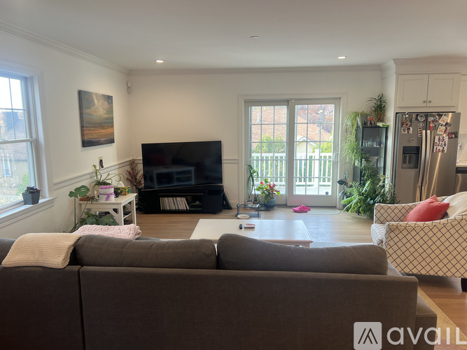A living room with a brown couch and a television.