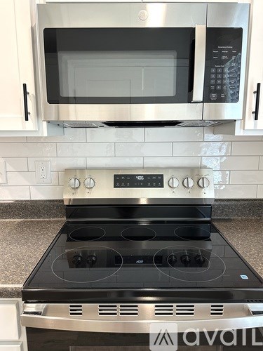 A stainless steel oven with a digital control panel is installed in a kitchen.