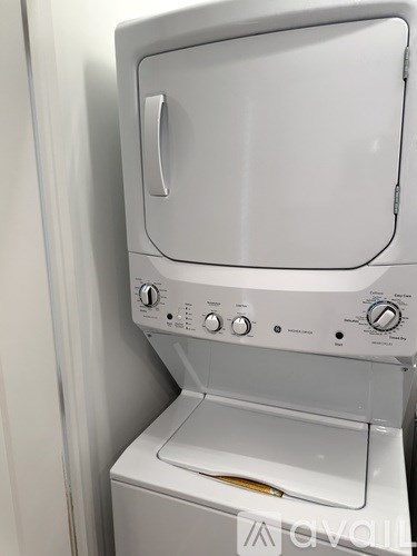 A white dryer is sitting on top of a white washing machine.