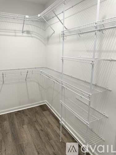 Empty shelving in a room with wood flooring.