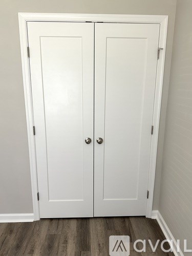 A white double door with a silver handle.