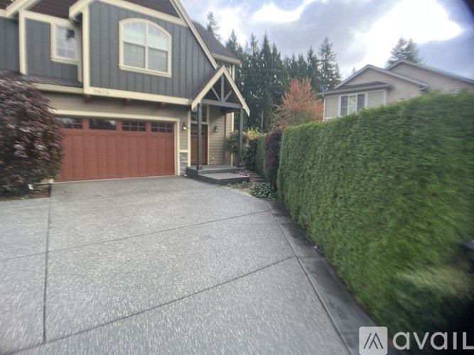 A house with a brown garage door and a driveway.