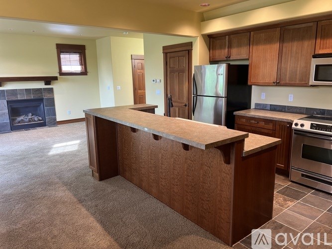 A kitchen with a wooden island in the middle of the room.