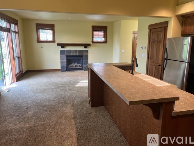 A kitchen with a fireplace and a refrigerator.