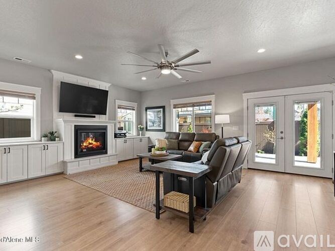 A spacious living room with a fireplace and a television.