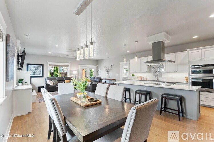 A modern kitchen with a dining table set for four.