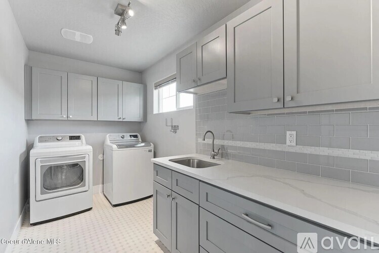 A kitchen with white appliances and cabinets.
