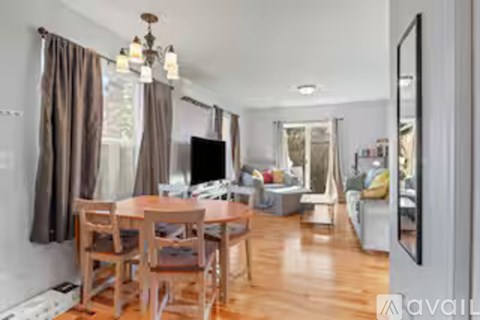 A living room with a wooden table and chairs.