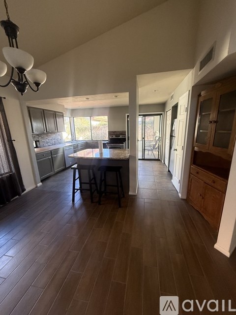 A kitchen with a table and chairs in the middle of the room.