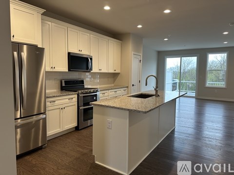 A kitchen with white cabinets and stainless steel appliances.