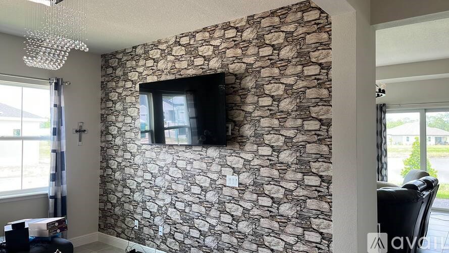 A stone wall with a television mounted on it.