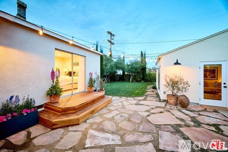 A house with a stone walkway leading to the front door.