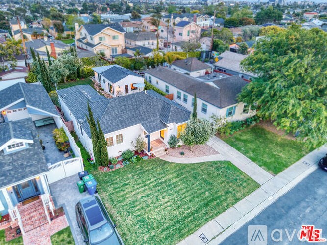 A house with a green lawn and a car parked in front.