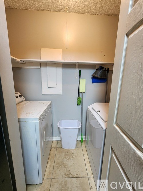 A small laundry room with a washer and dryer.