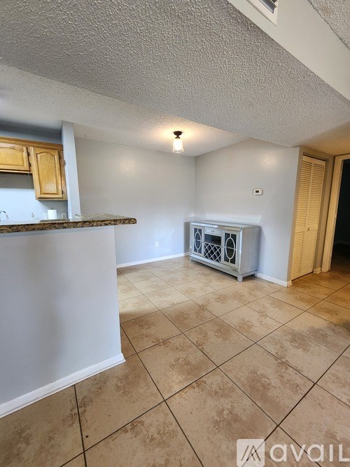 A room with a tiled floor and a white wall.