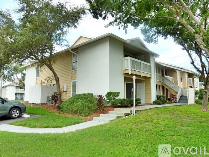 A two-story house with a balcony on the second floor.