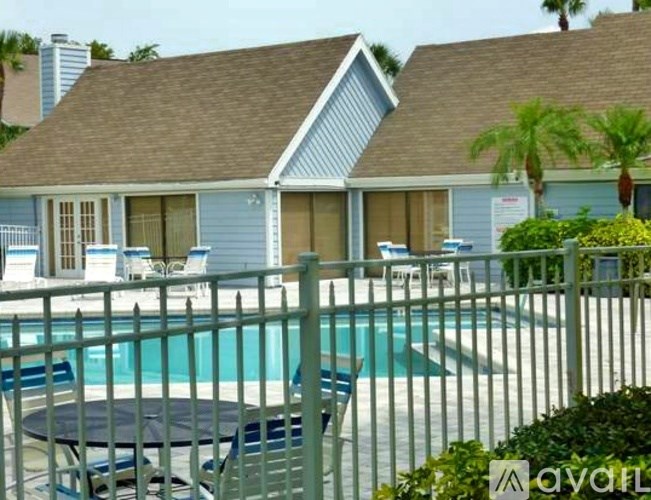 A house with a pool in front of it.