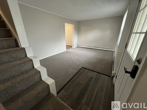 A room with a staircase leading to the upper floor.