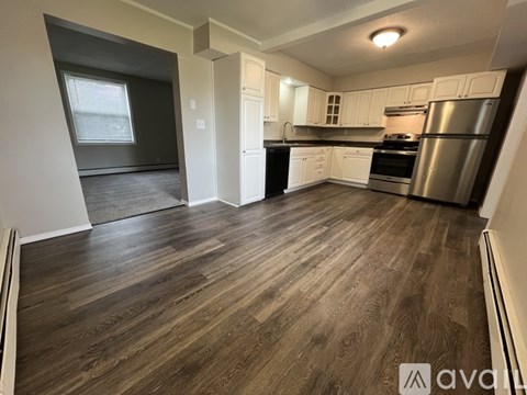 A kitchen with wooden floors and stainless steel appliances.