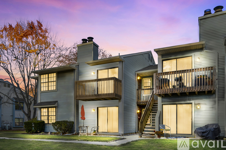 A modern two-story house with a balcony and a garage.
