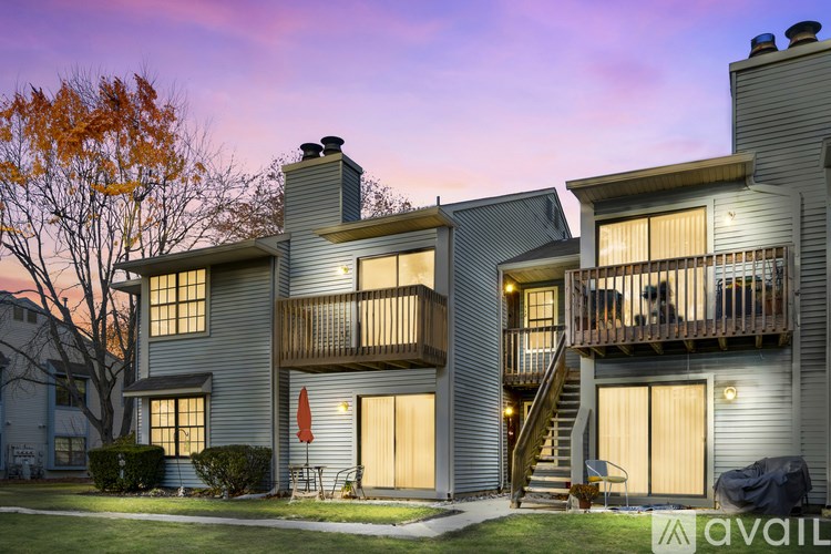 A modern two-story house with a balcony and a garage.