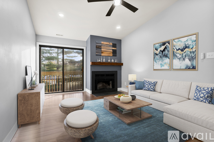 A modern living room with a fireplace and a sliding glass door.
