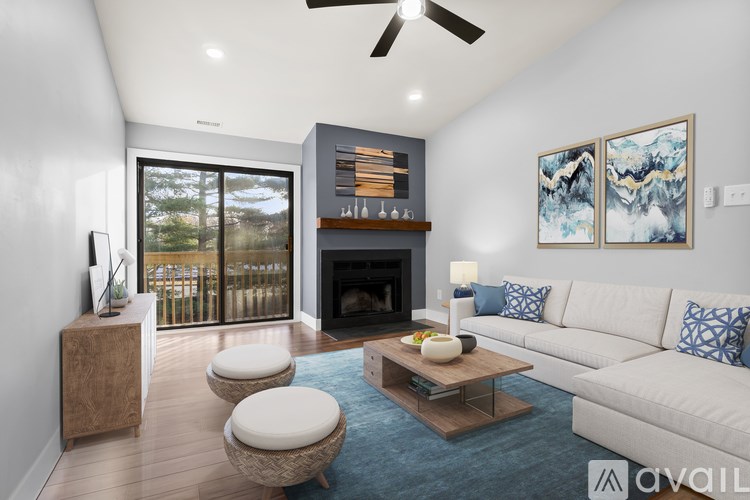 A modern living room with a fireplace and a sliding glass door.