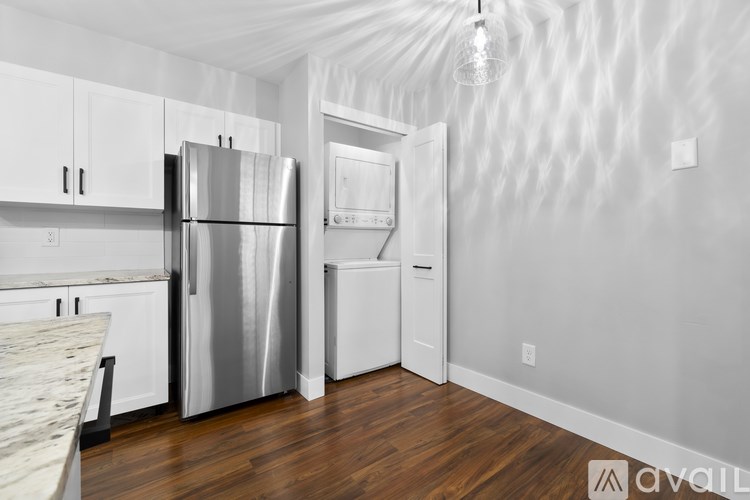 A kitchen with a refrigerator, oven, and dishwasher.