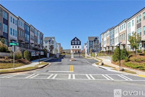 A street view of a residential area with a crosswalk in the foreground.