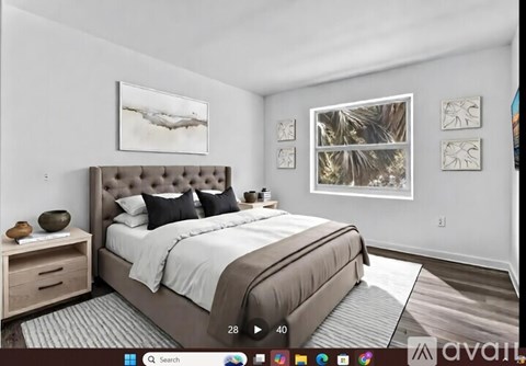 A bedroom with a large bed and a painting on the wall.