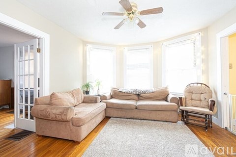 A living room with a beige sofa and a matching armchair.
