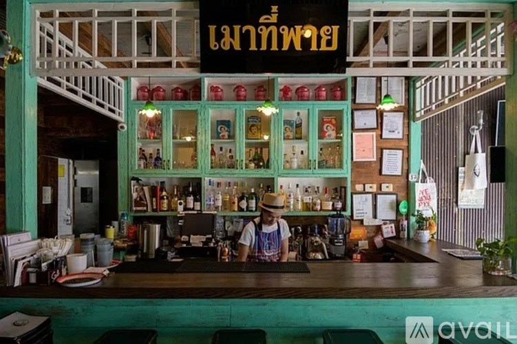 A bar with a person behind the counter.