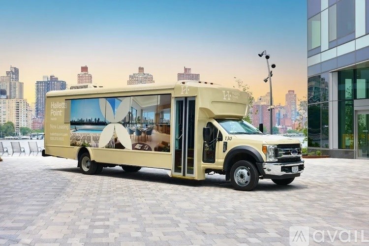 A food truck with a menu on the side is parked in a city.