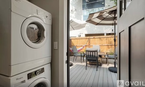A washing machine is on the left and a patio with chairs is on the right.