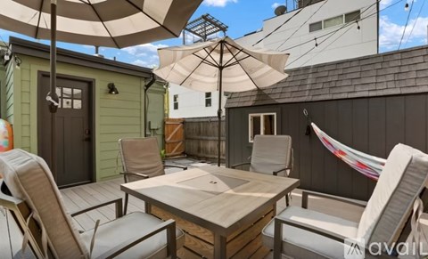 A patio with a table and chairs under a canopy.