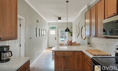 A kitchen with wooden cabinets and a white countertop.