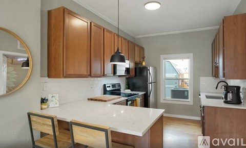 A kitchen with wooden cabinets and a white countertop.
