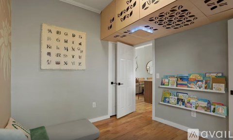 A room with a white door and a wall with alphabet letters on it.