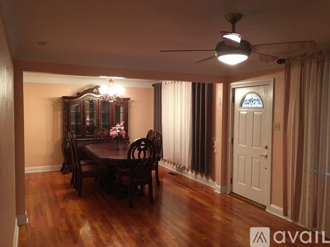 A dining room with a table set for four.