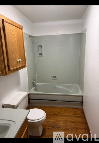 A bathroom with a toilet, sink, and shower.