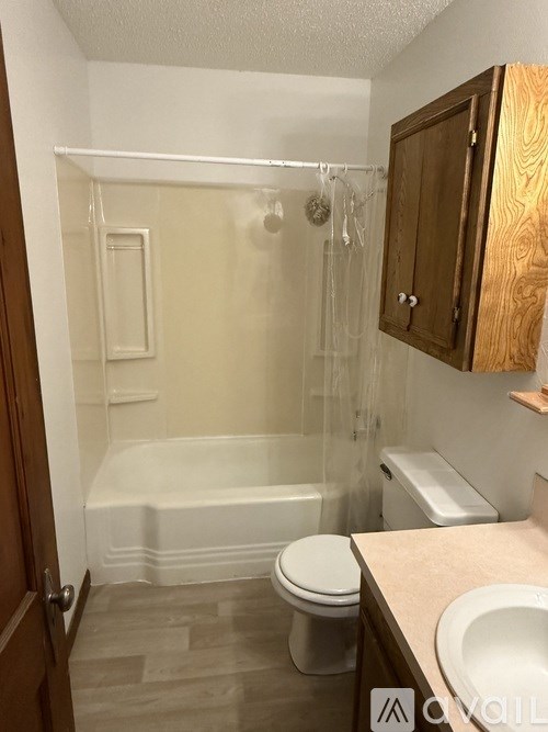 A small bathroom with a toilet, sink, and bathtub.