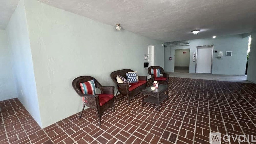 A living room with a couch, chairs, and a coffee table.