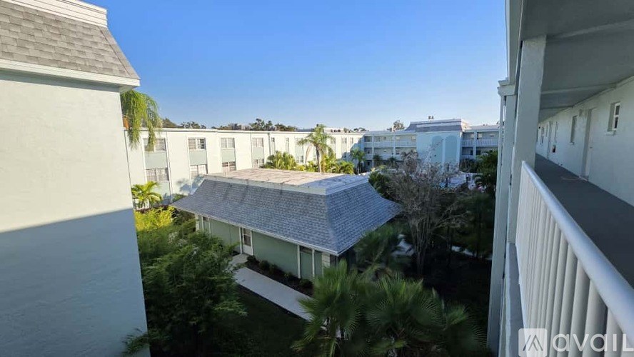 A view from a balcony of a building with a clear blue sky above.